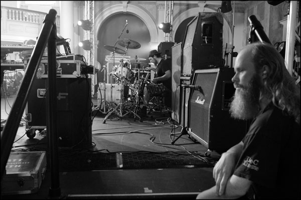 Stage tech and the drummer from Drallion, Hammerdown Festival 2022, by Greig Clifford