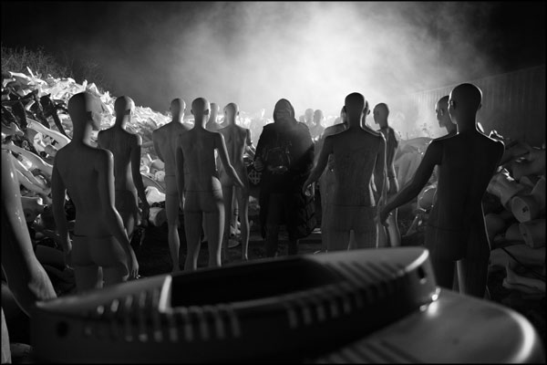 Between takes. Shaun Hodson / Loki Films looks back through a crowd of mannequins. Photography by Greig Clifford