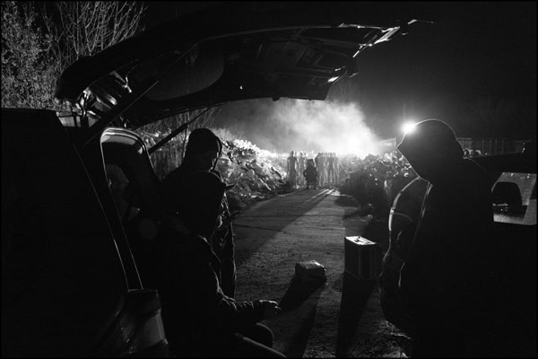 During a break in filming. Chatting under a car's open hatchback. Photography by Greig Clifford